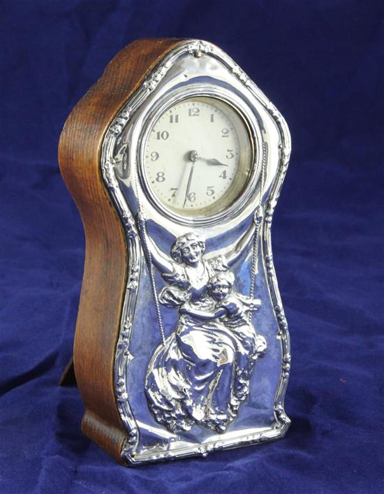 An Edwardian silver mounted wooden mantel timepiece, approx. 7in.